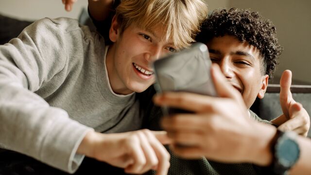 Two young man looking at the phone - small